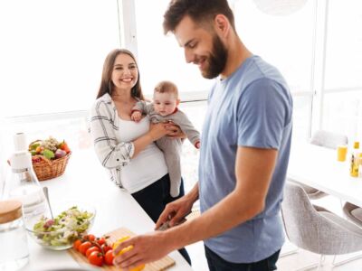 happy-parents-with-their-baby-son-cooking-in-kitch-2021-08-26-18-23-49-utc