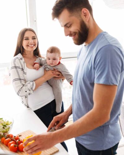 happy-parents-with-their-baby-son-cooking-in-kitch-2021-08-26-18-23-49-utc