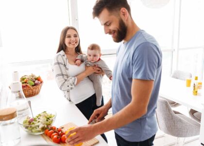 happy-parents-with-their-baby-son-cooking-in-kitch-2021-08-26-18-23-49-utc
